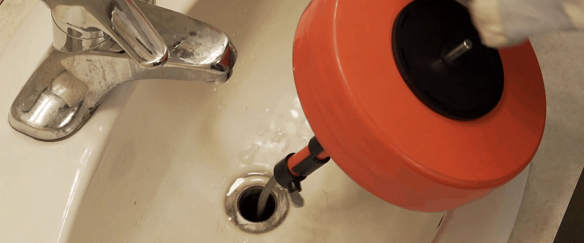 how to clear drain clog use auger snake rooter pipe